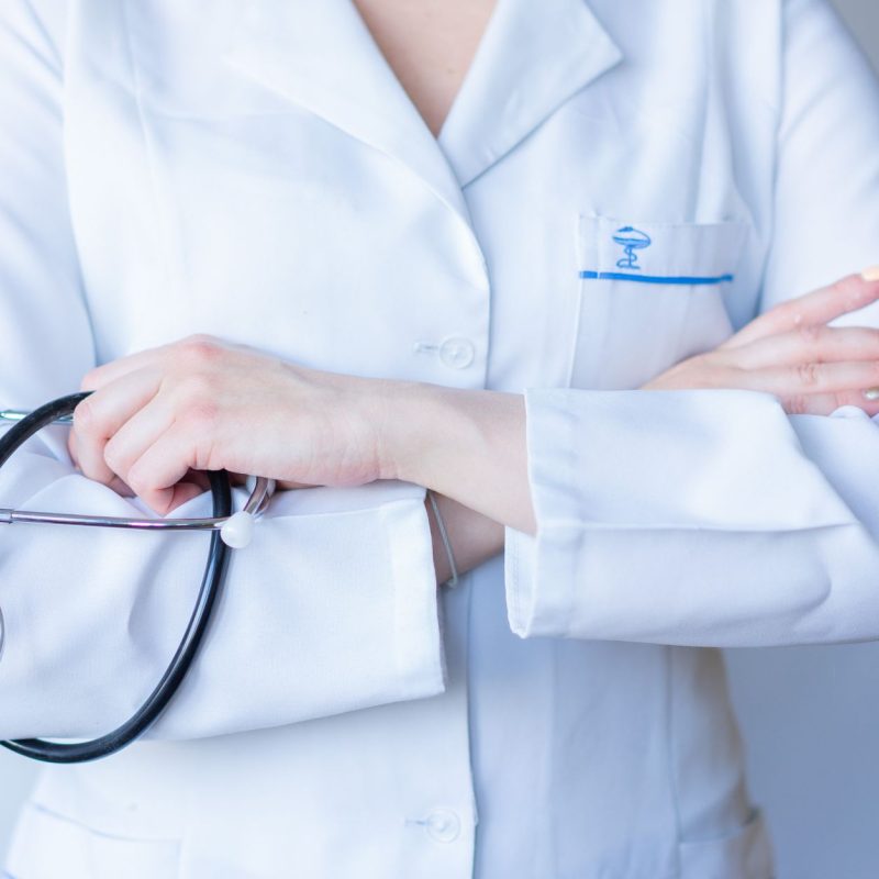 A close-up image of a doctor in a white coat with a stethoscope and arms crossed. — 9 Humorous Jack Sparrow Costs - Pirates o