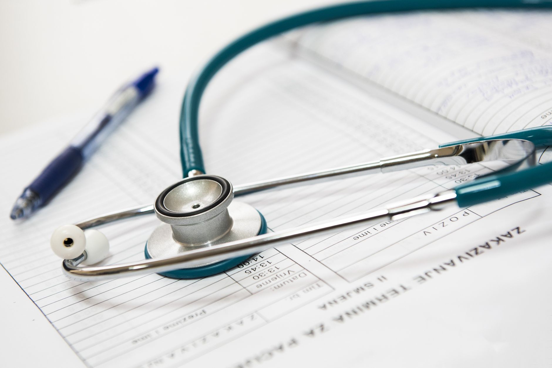 A stethoscope and pen resting on a medical report in a healthcare setting. — Don't Give Up on Hair Decline Remedy plans But -
