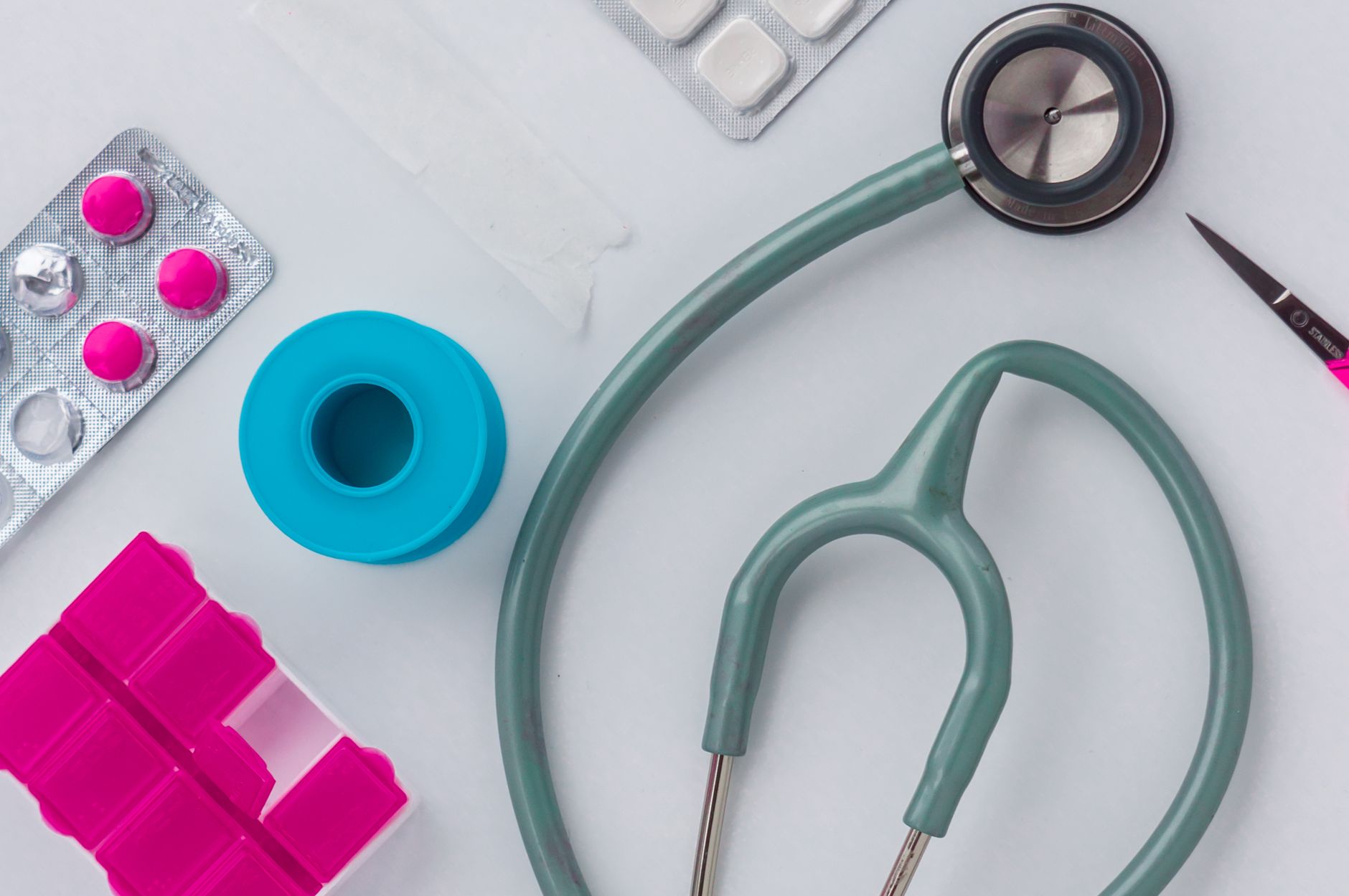Overhead shot of medical supplies including stethoscope, pills, and scissors. — Famend Costs on Personal Adversity