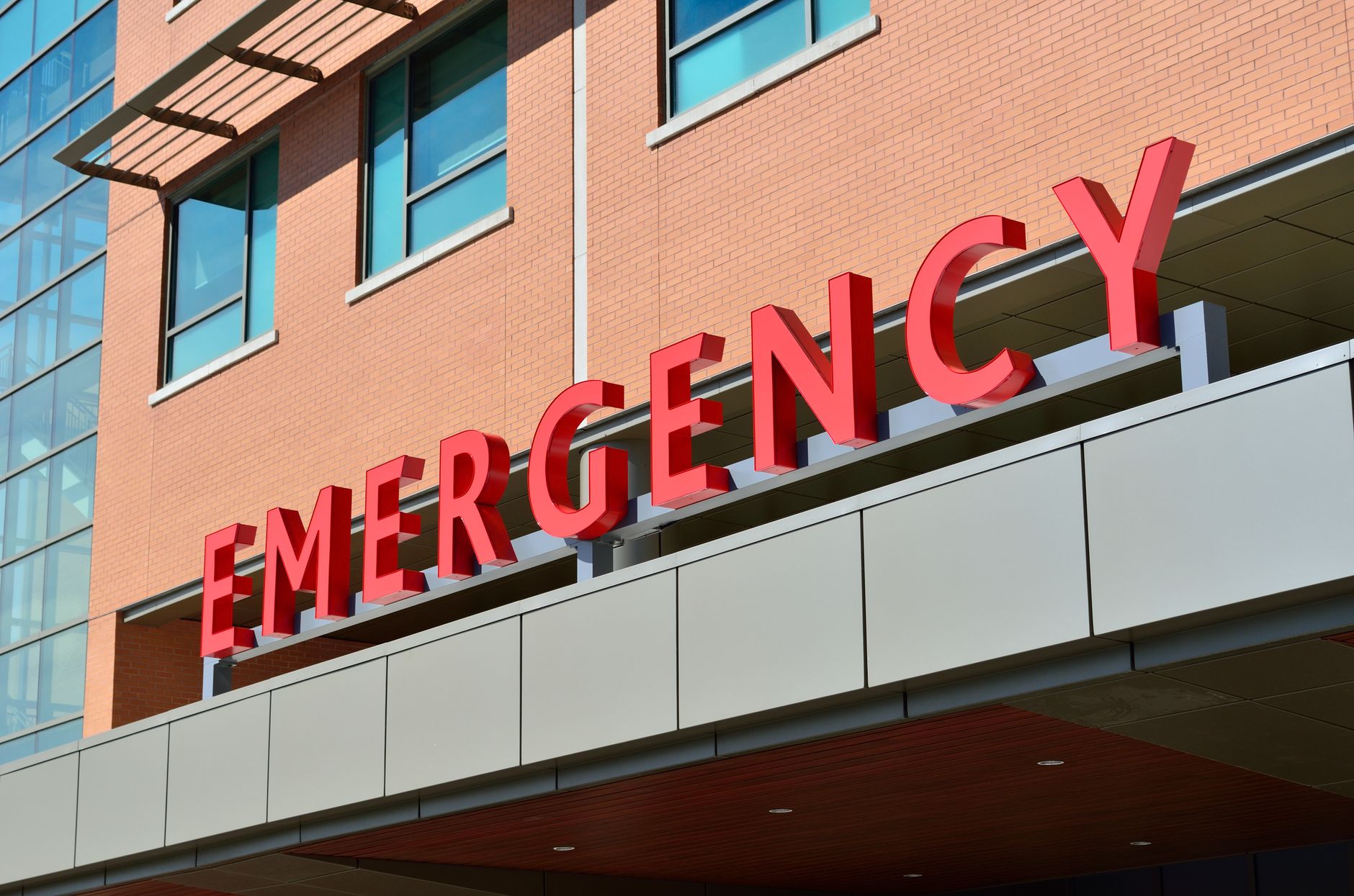 Close-up of a modern hospital emergency room entrance with prominent red letters. — Hair Loss in Squirrels