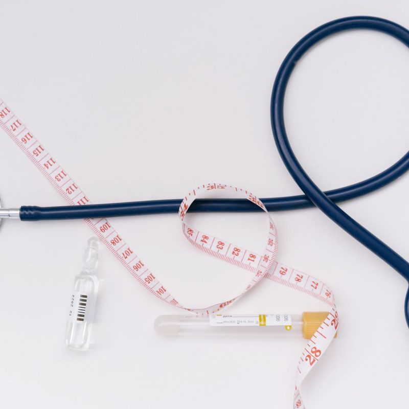 A stethoscope, ampoule, and tape measure on a white background symbolize healthcare essentials. — How Does Chakra Meditation