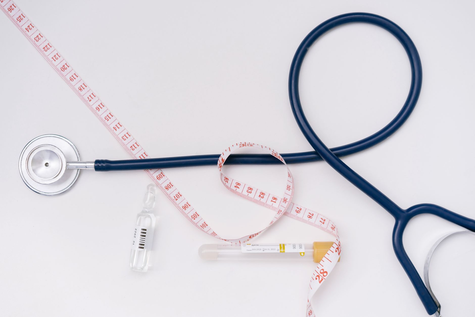 A stethoscope, ampoule, and tape measure on a white background symbolize healthcare essentials. — How Does Chakra Meditation