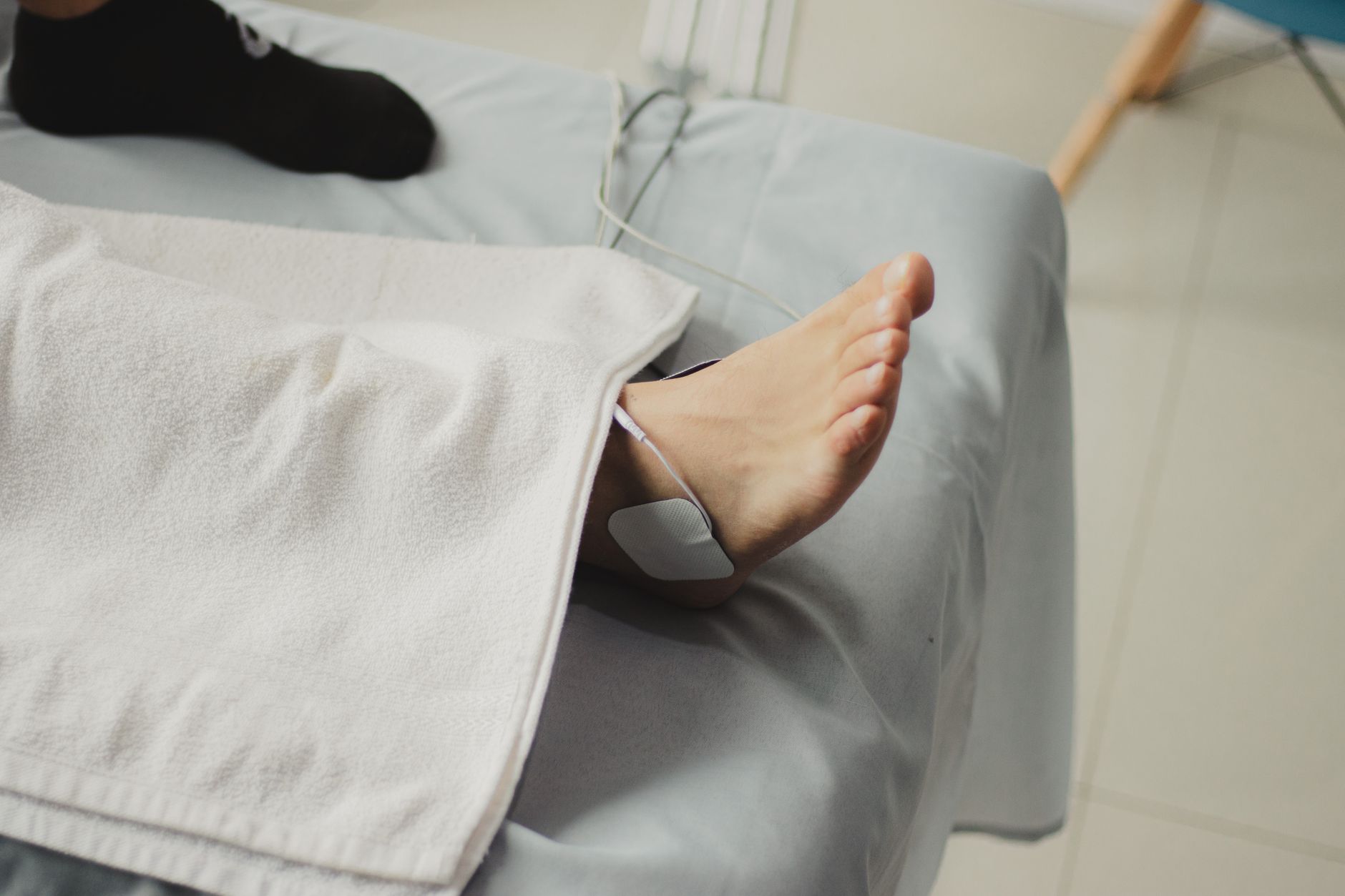 A close-up image of a bare foot with a medical electrode, suggesting a healthcare setting. — Medisuggestion - The Environment