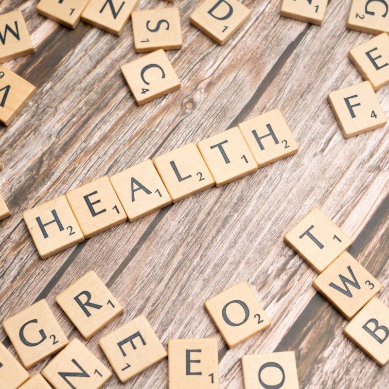 Scrabble tiles spelling 'HEALTH' on wooden surface, symbolizing wellness. — Pomeranian Hair Decline: Will trigger and Cures