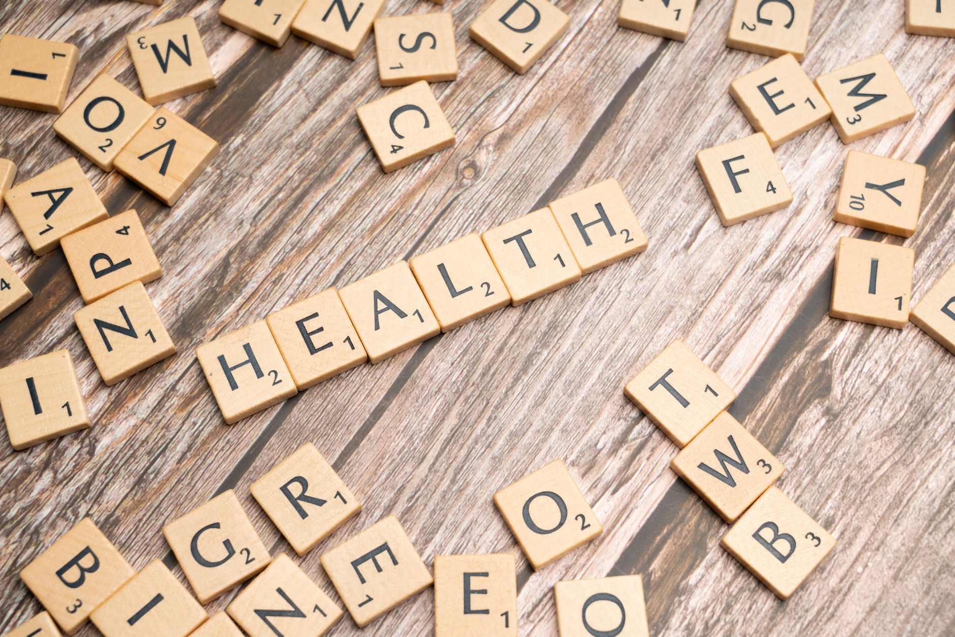 Scrabble tiles spelling 'HEALTH' on wooden surface, symbolizing wellness. — Pomeranian Hair Decline: Will trigger and Cures