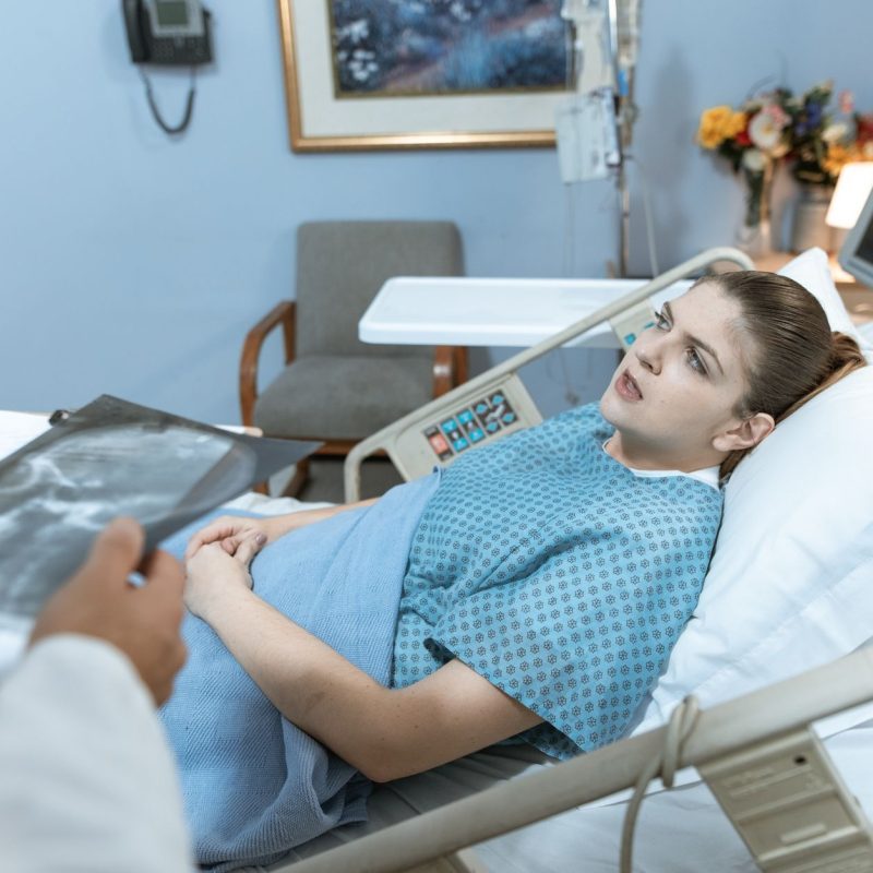 Caucasian woman in hospital bed receiving care from healthcare professional. — Reserve Overview: 10% Happier - How Meditation