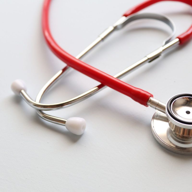 Close-up of a red stethoscope symbolizing medical care and healthcare diagnostics. — The Symbolic Indicating of the 'Lotus Bu