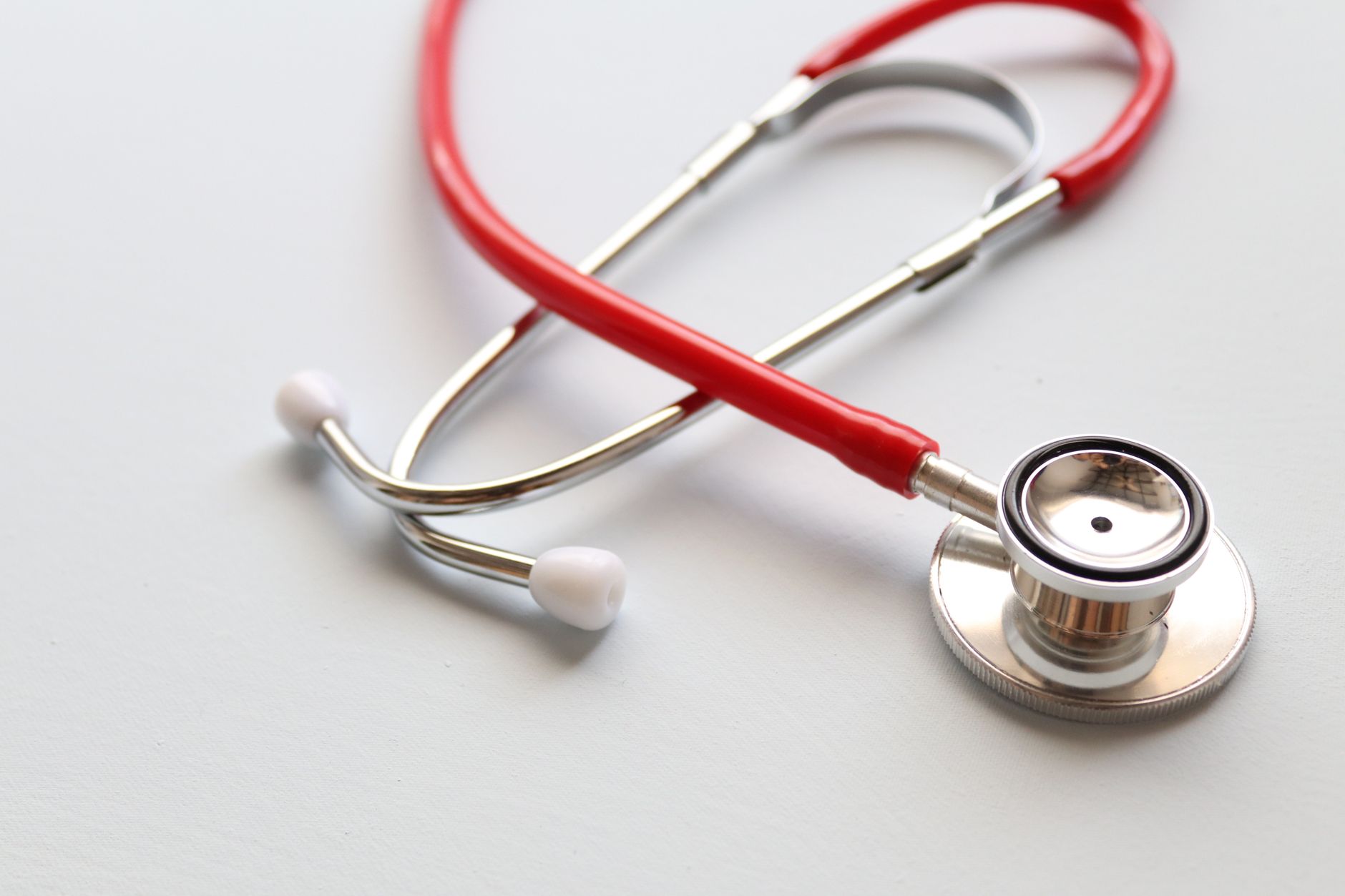 Close-up of a red stethoscope symbolizing medical care and healthcare diagnostics. — The Symbolic Indicating of the 'Lotus Bu