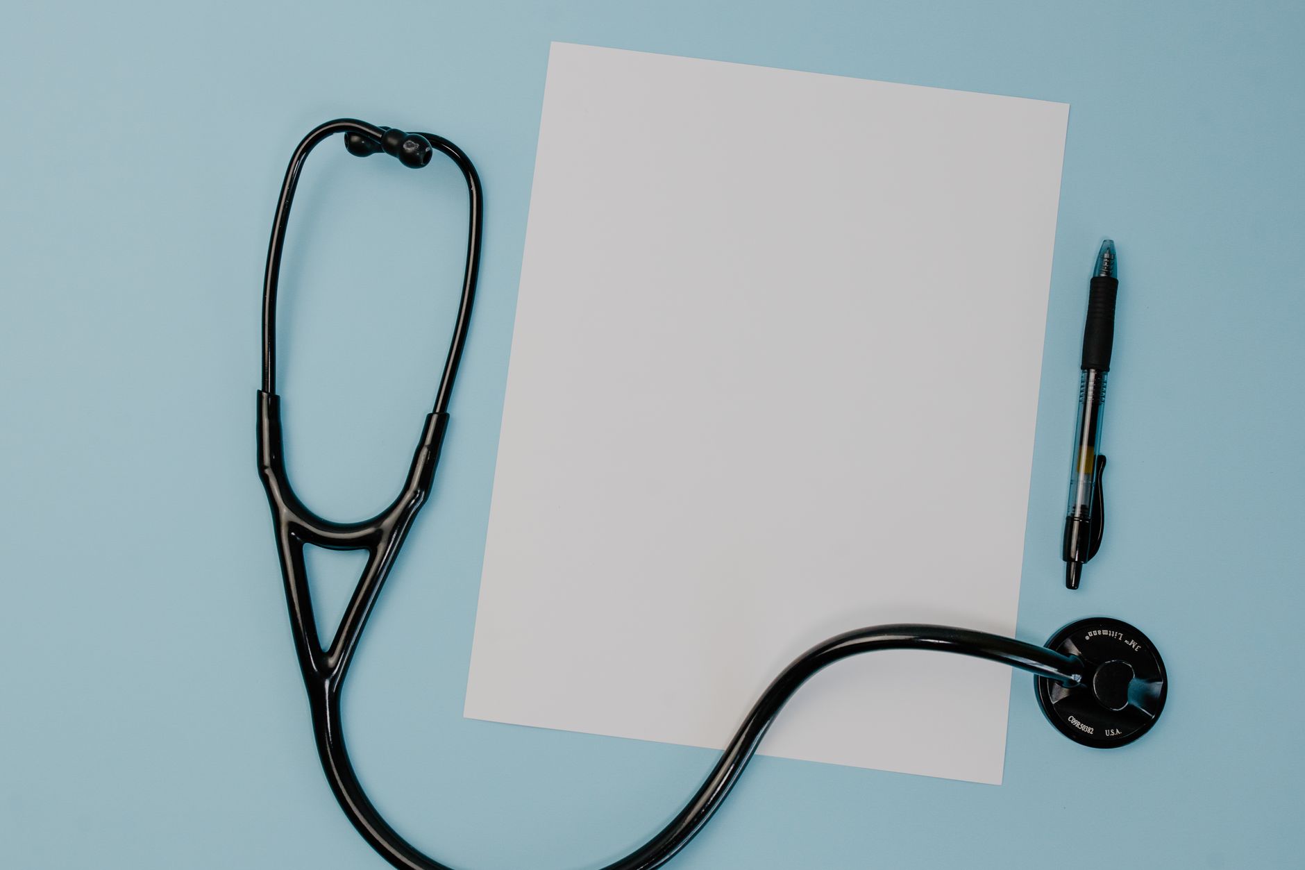 Flat lay of a stethoscope, blank paper, and pen on a blue background. — Why You Actually ought to Use Follinex To Stop Thinni